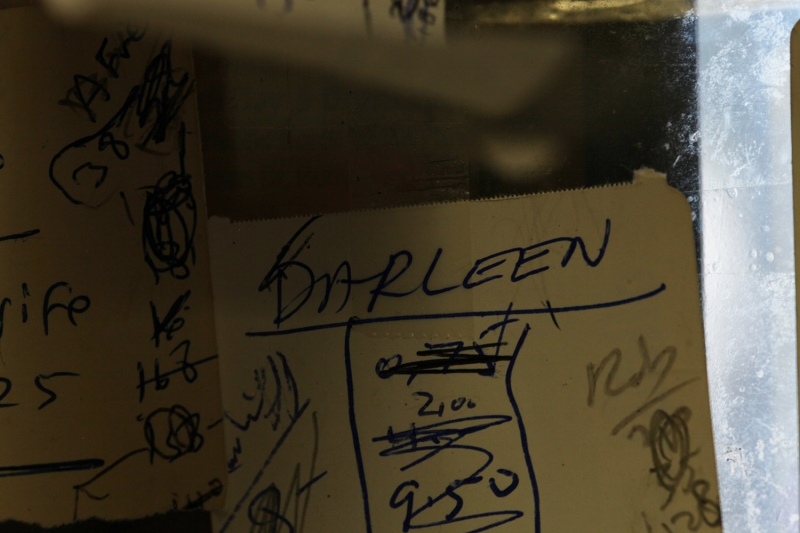 A close-up of cardboard on dirty glass, the word