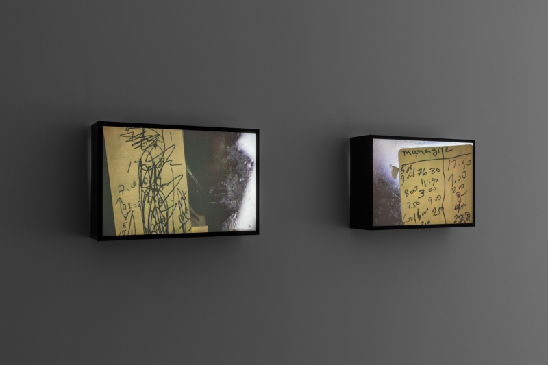 A close-up of cardboard on dirty glass, the word