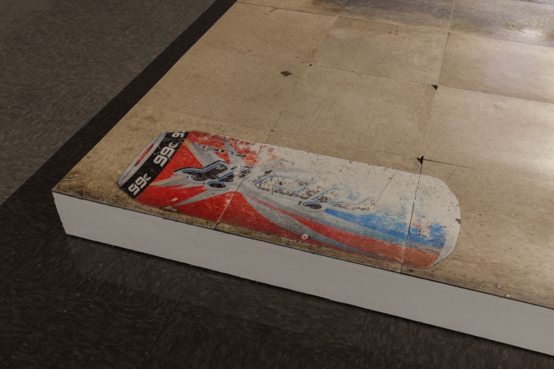 A close-up of cardboard on dirty glass, the word