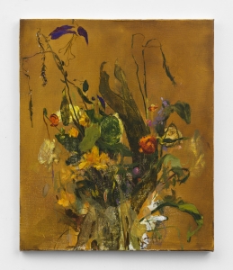 A bouquet of yellow, gold, green, orange and purple flowers against a mustard background