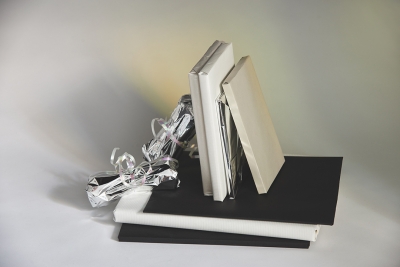 Books and gifts wrapped in silver, beige and black paper