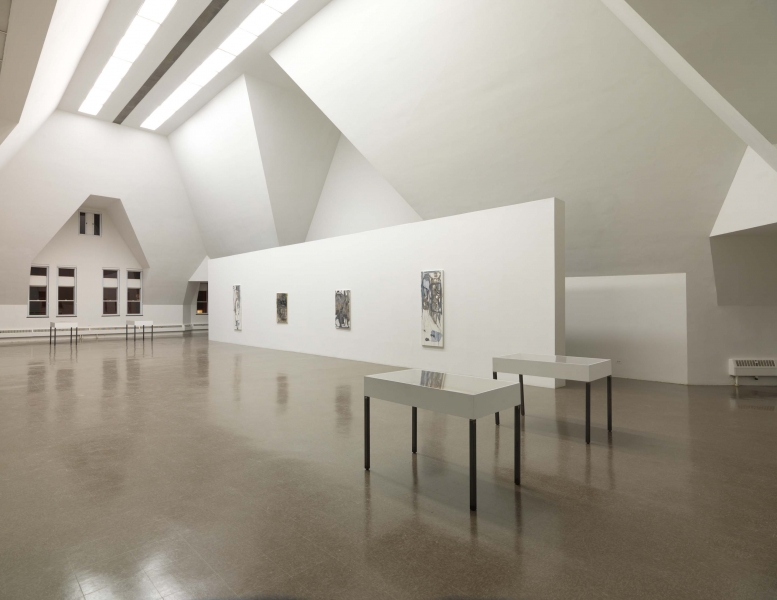 A thin white painting, with black lines, blue and dark gray smears leaving a triangle of white space at bottom left