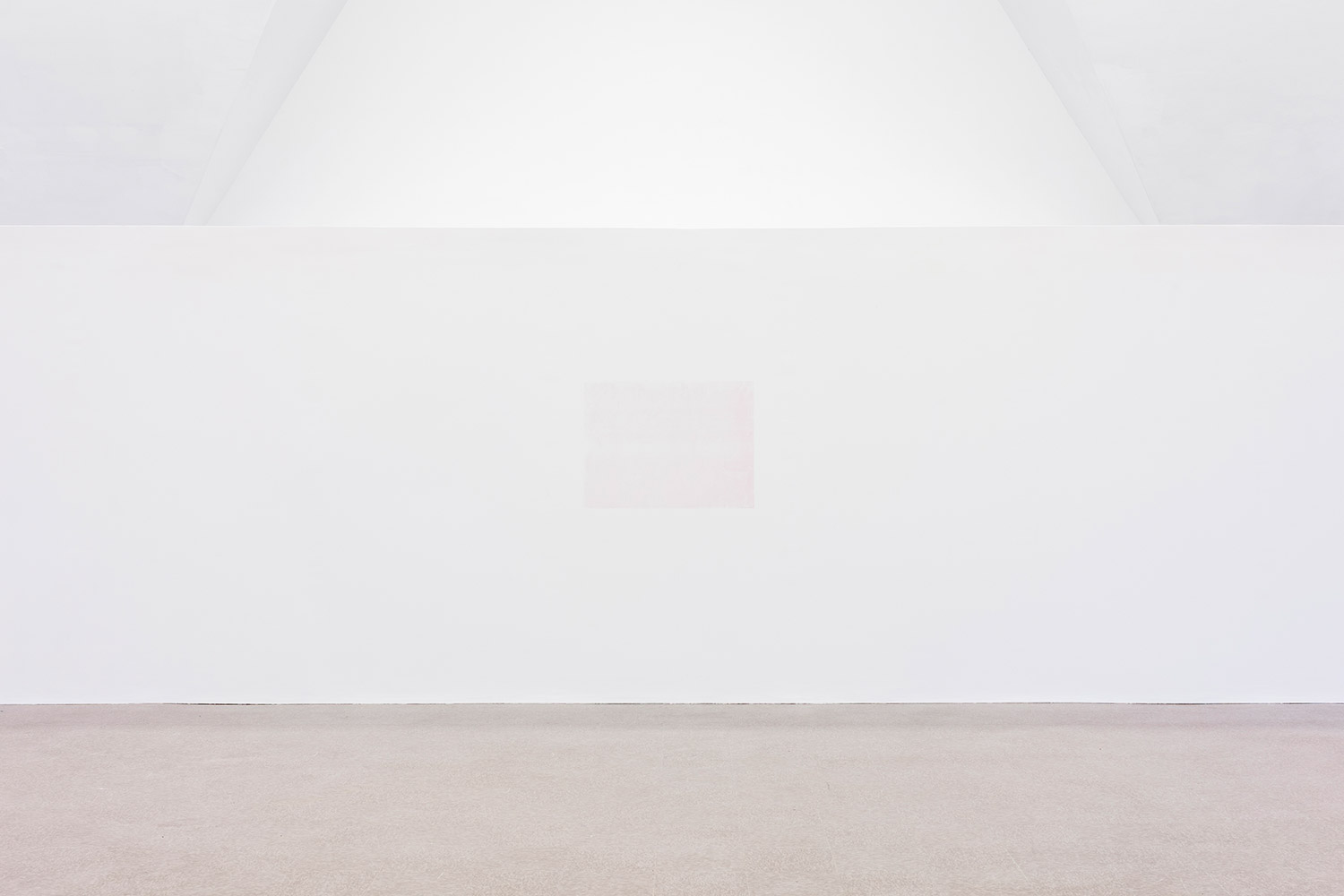 A faint reddish-pink silkscreen in the center of a long white wall