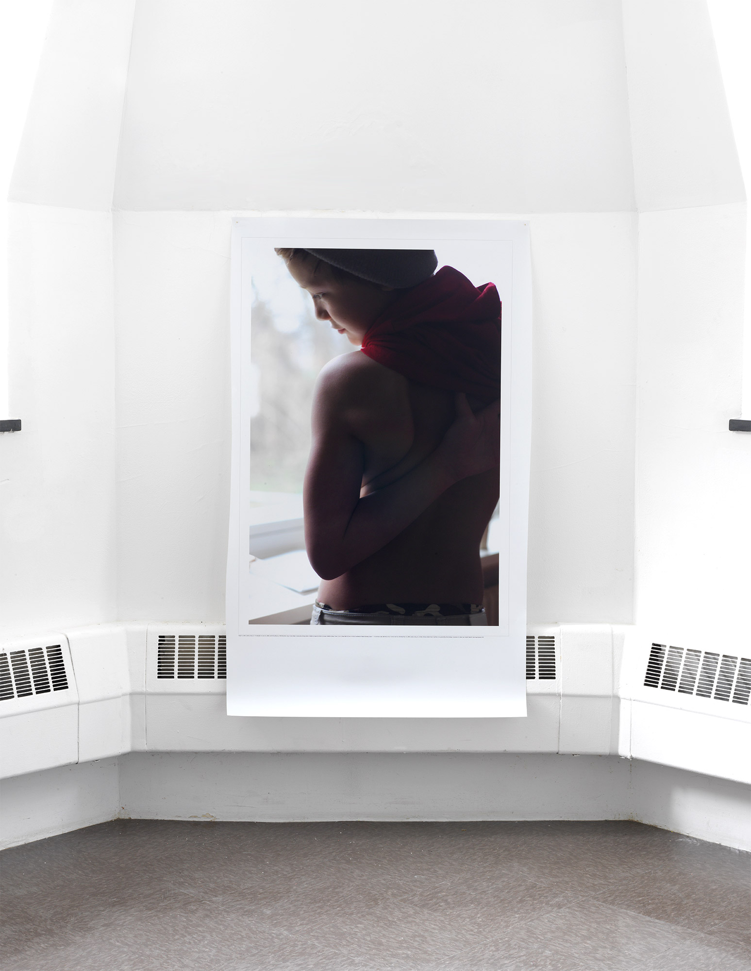 A large print of a child looking through a light window