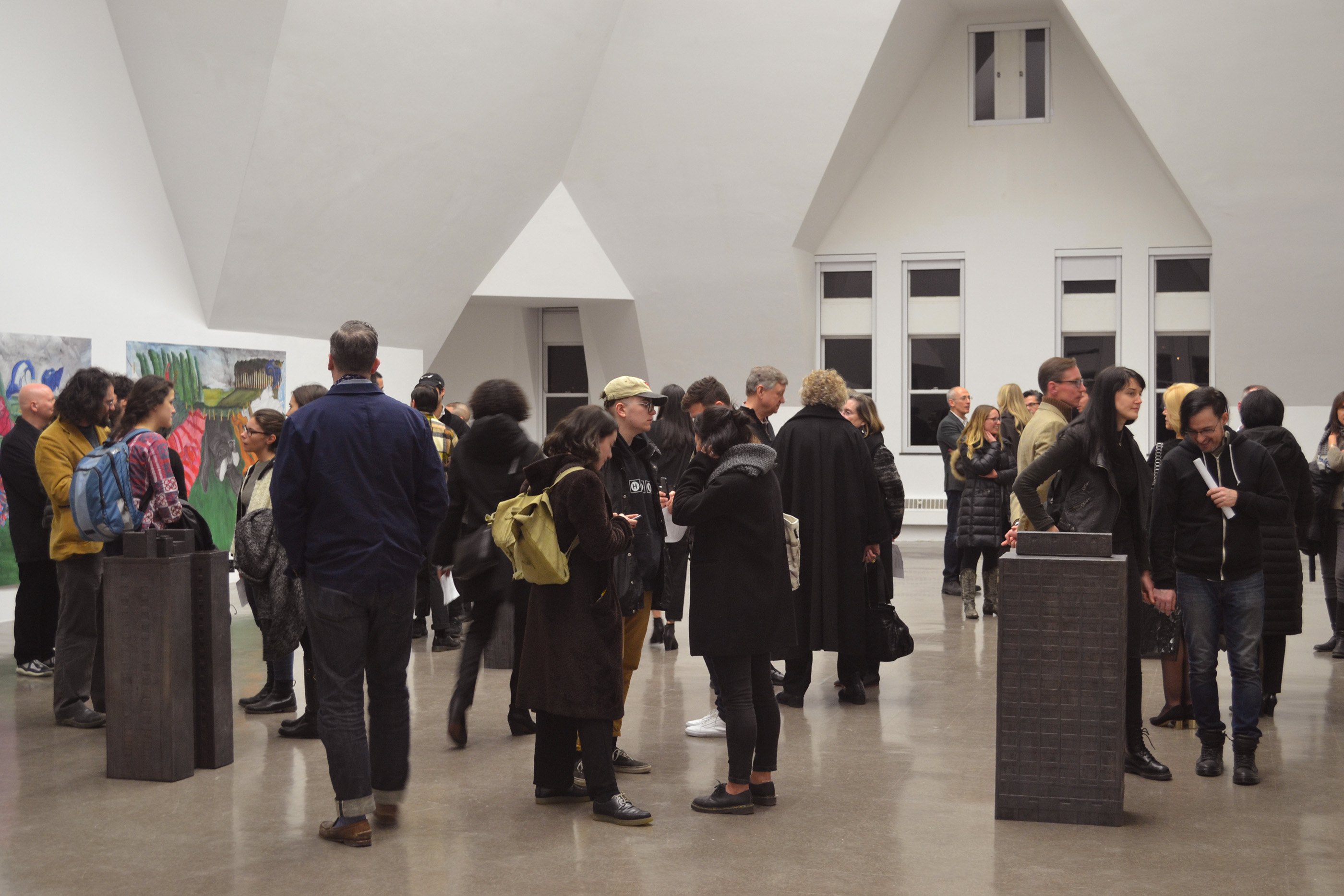 A crowd fills the room at an exhibition.